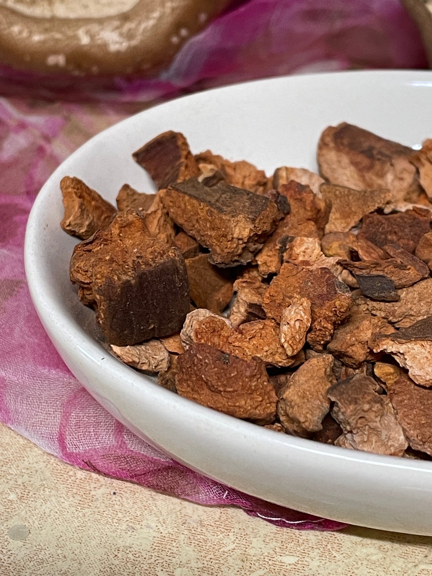 cinchona bark resting in a vintage stoneware bowl.
