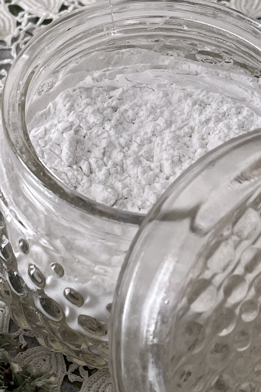 Open powder dish overflowing with natural organic body powder, showcasing a gentle, chemical-free formula made from pure, plant-based ingredients. Ideal for soothing and refreshing skin, offering a natural alternative to traditional body powders.