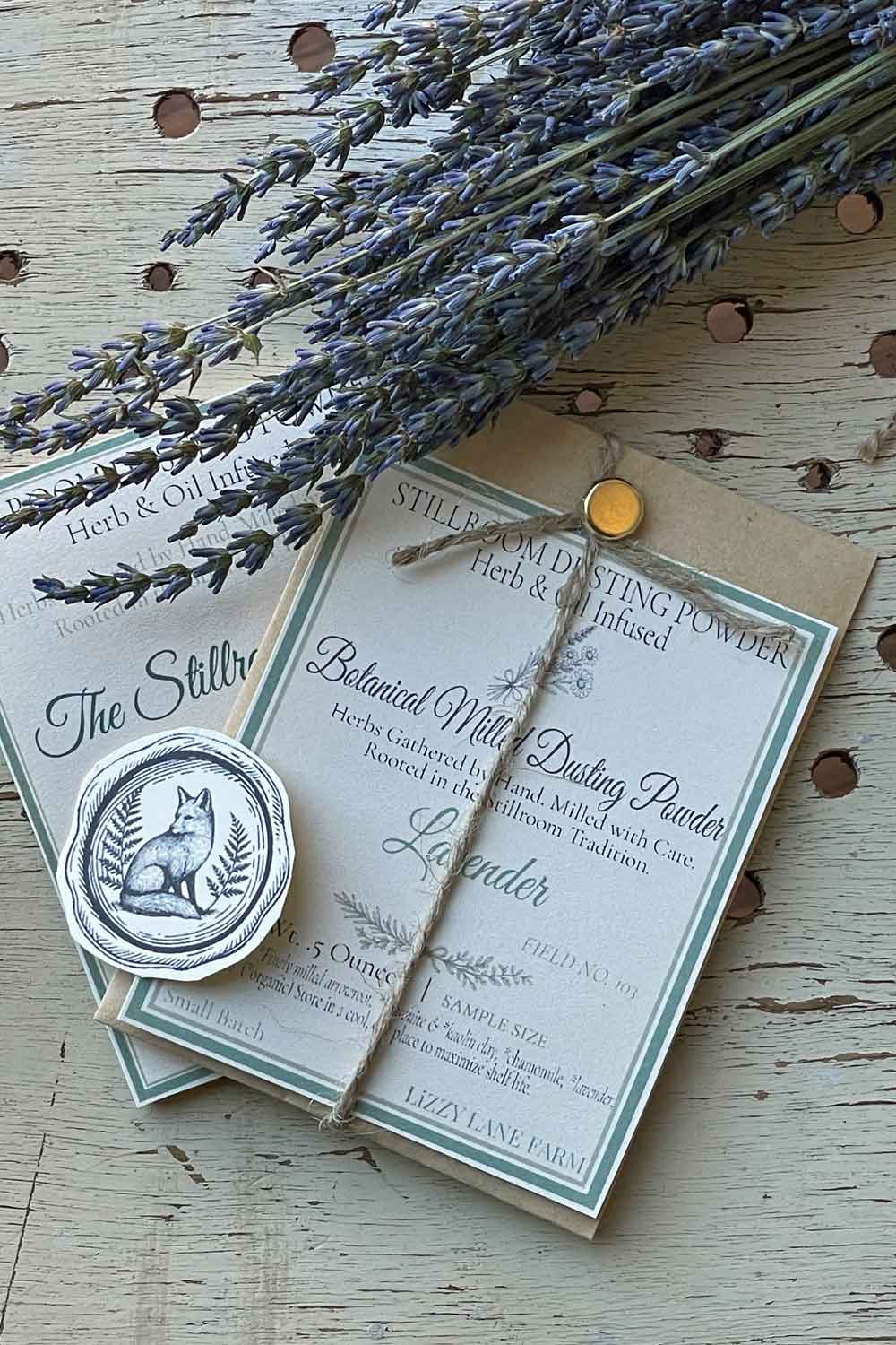 Field No. 103 Herbal Lavender Dusting Powder — sample size in kraft coin envelope with brass clasp, twine, and fox seal. Herb & Oil Infused talc-free body powder, part of the Stillroom Archive Collection.