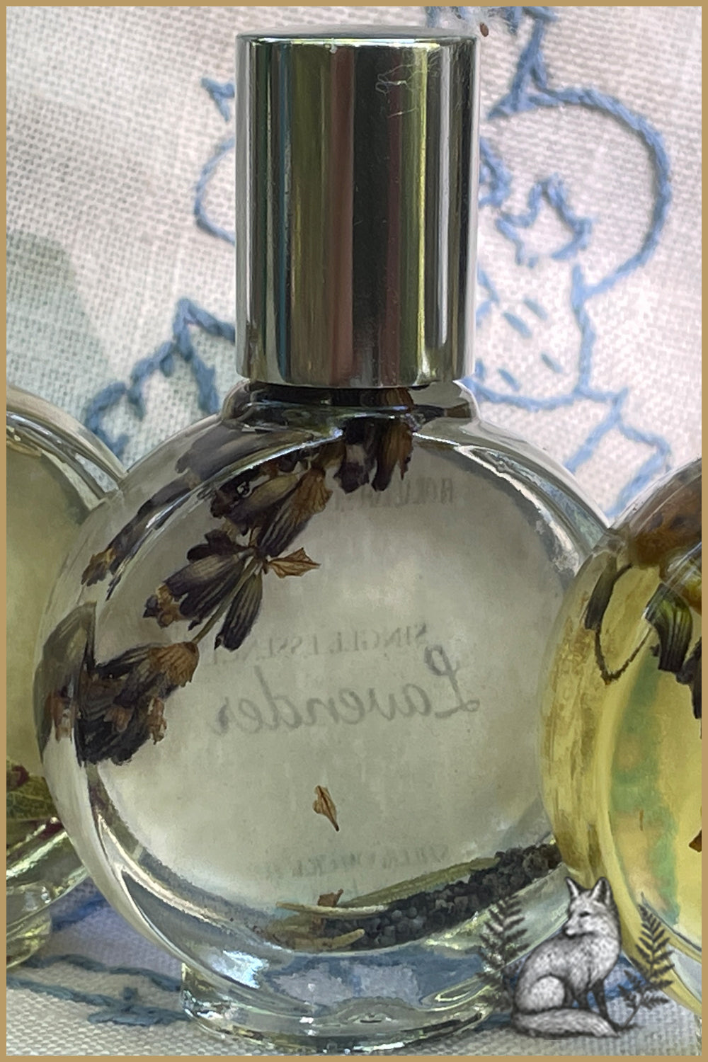 Watchface bottle of floral infused perfume oil, lavender.