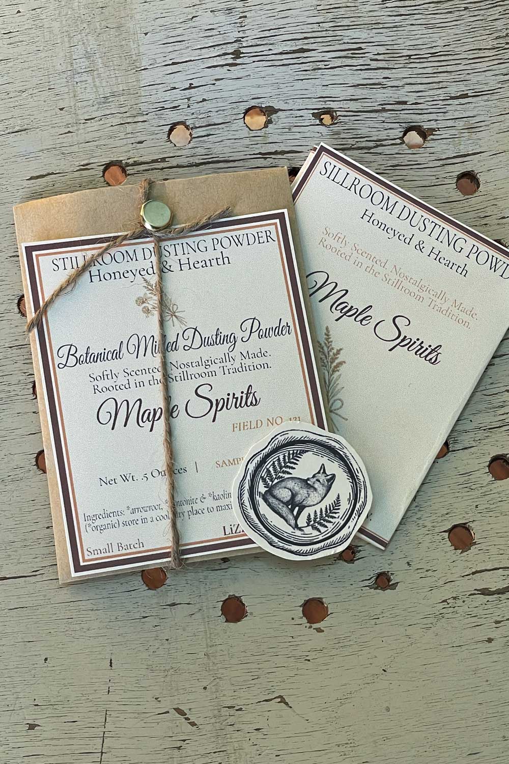 Maple Spirits seasonal dusting powder, sample sized packaging with series archival card introduction