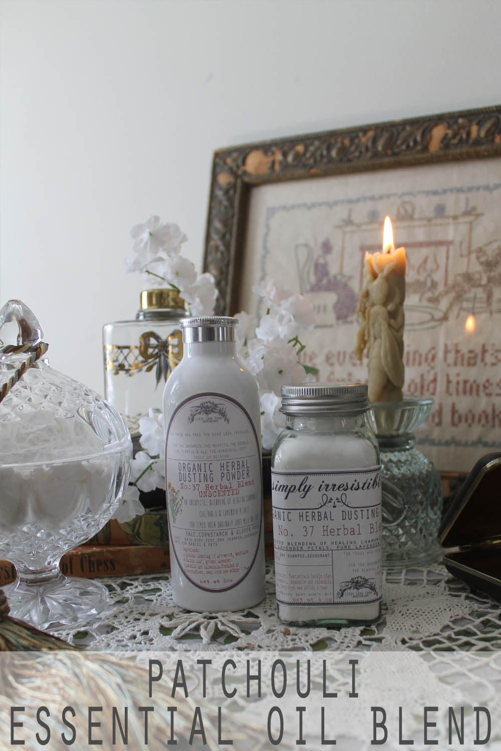 A beautifully arranged bottle of patchouli-infused herbal dusting powder, nestled among dried botanicals on a vintage wooden tray. This natural, talc-free powder is crafted to soothe and balance the skin with the earthy richness of patchouli essential oil.