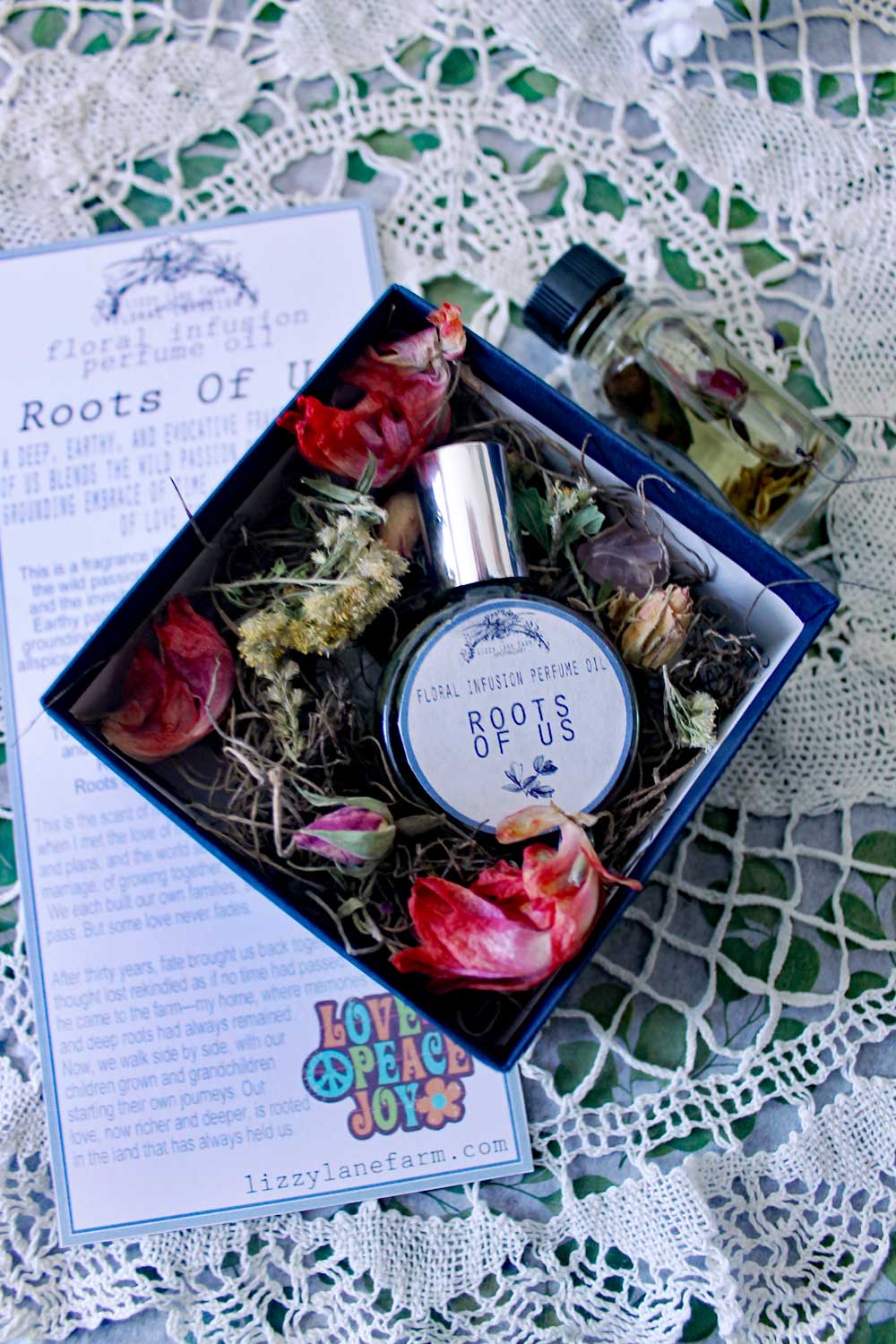 beautiful boxed floral infusion perfume nested on a layer of dried flowers and herbs