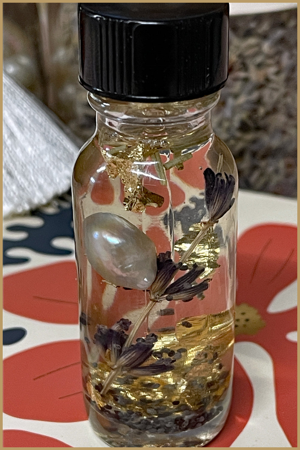 The old arm chair floral infused perfume oil with dried lavender, a pearl and gold flakes