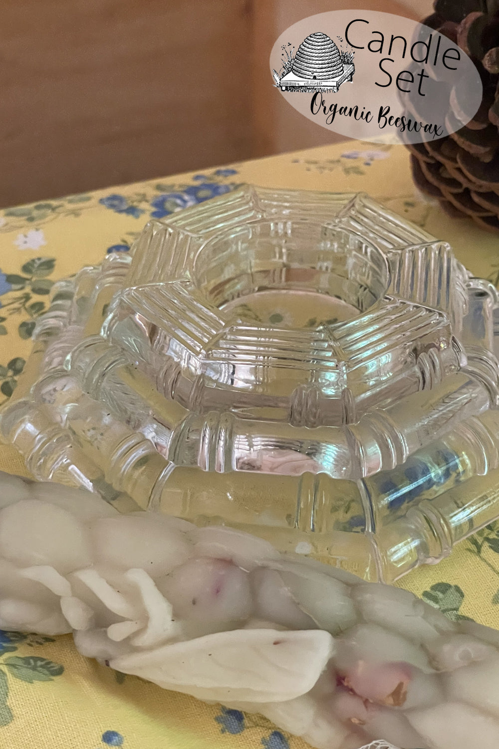 Vintage clear pressed glass candle holder with Art Deco styling shown on a lace-covered table in soft light. Photographed upright and flipped to show two uses: tealight and pillar candle support.