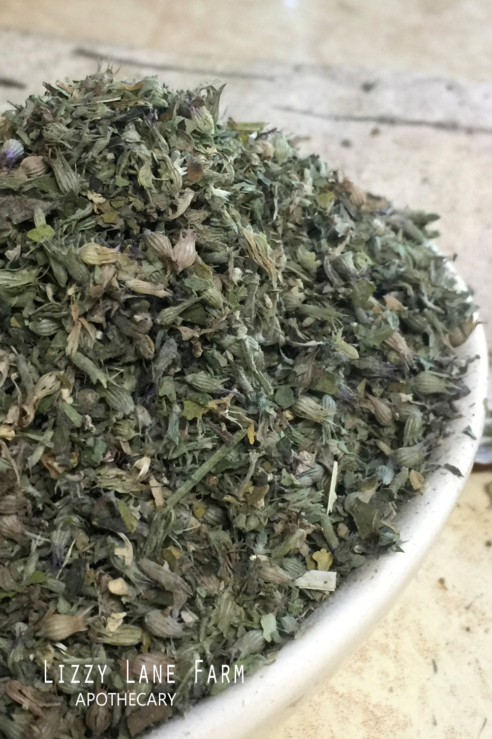 dried cat nip cut and sifted in an overflowing vintage ironstone bowl. close up of fine detains and freshness of the cat nip