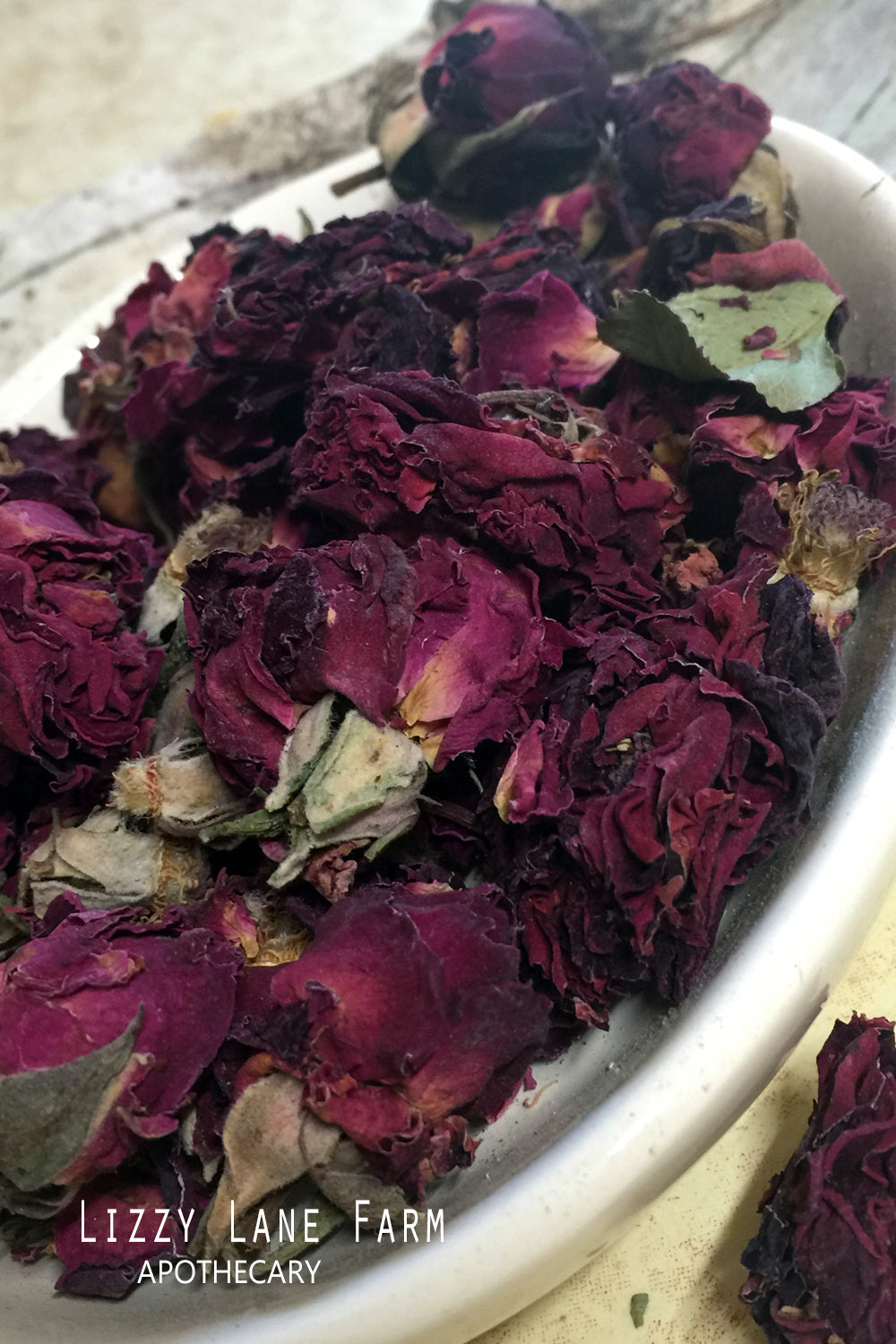 Dried Rose Buds in a Ceramic Bowl – Organic dried red rose buds elegantly displayed in a handcrafted ceramic bowl. Vibrant, fragrant, and perfect for tea, potpourri, and natural skincare.