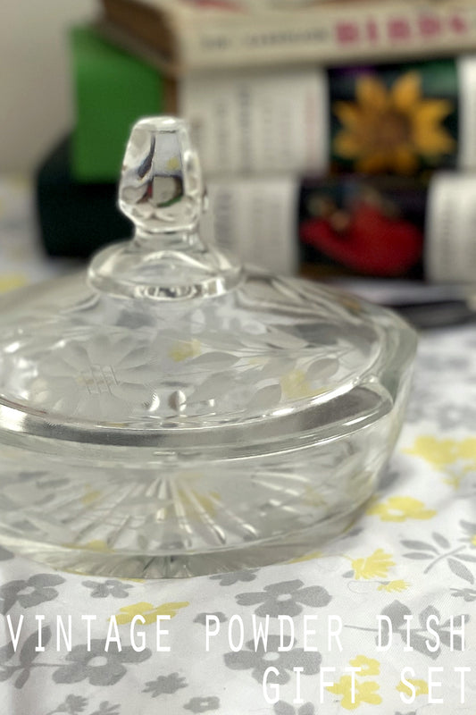 Close-up of etched daisy detail and notched glass edge catching the sunlight.