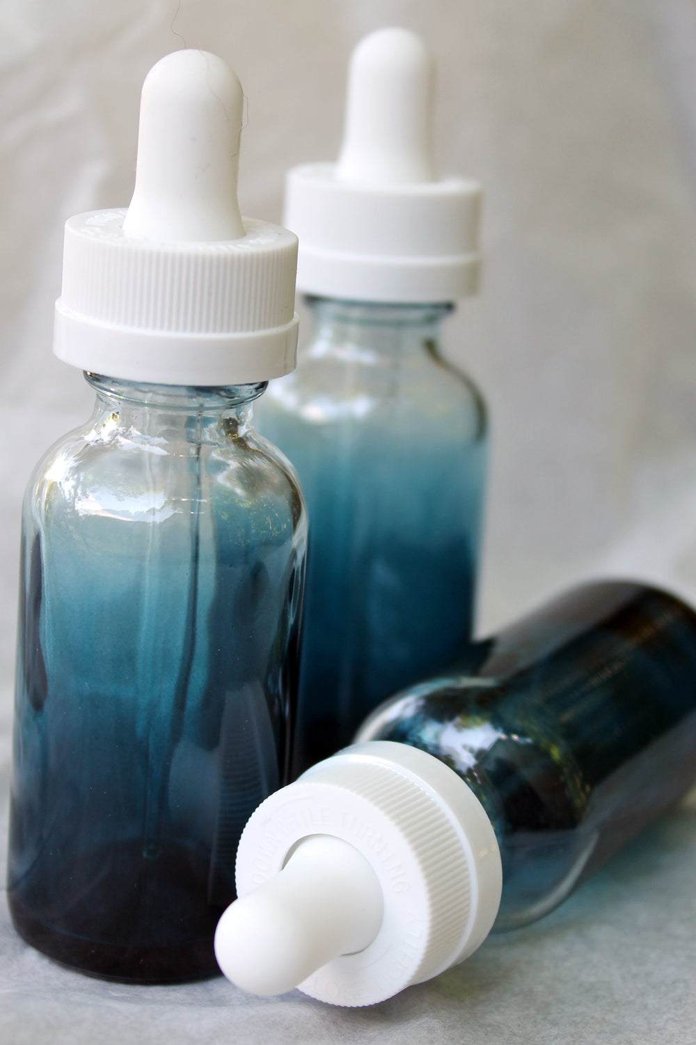 blue shaded boston roud bottles with dropper caps 1 ounce