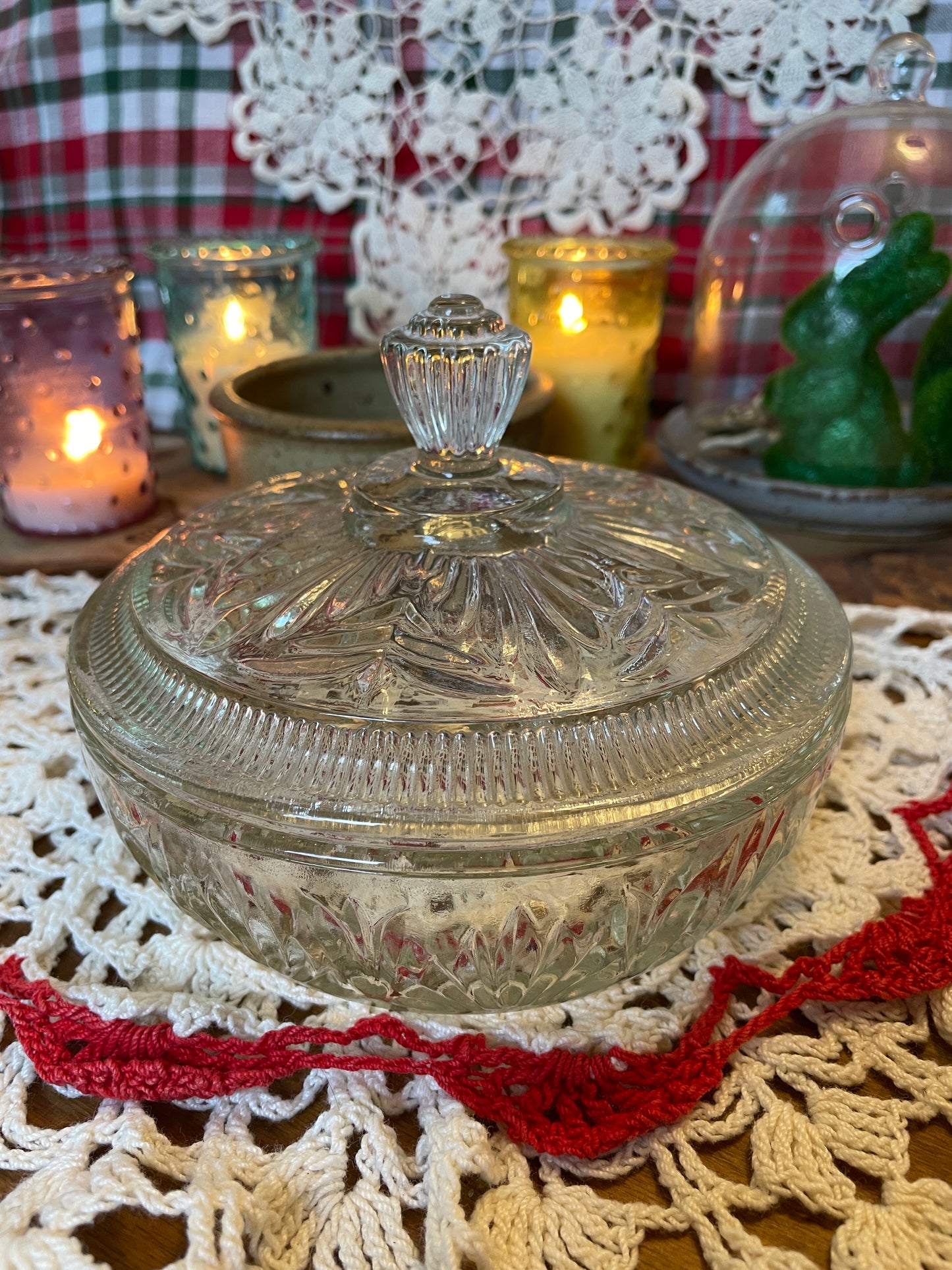 Full view of the Avon powder dish set, with Candied Lilac body powder  resting on the vintage doily with candles glowing softly in the background.