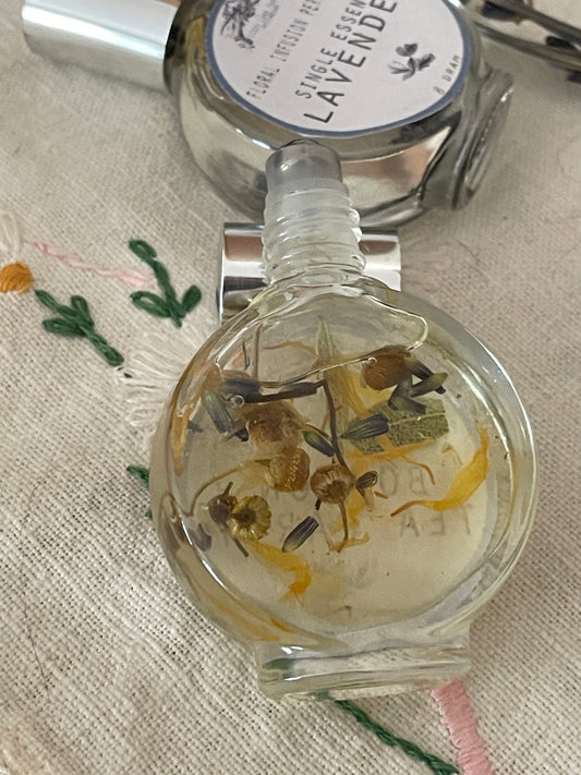 a detailed view of the boston tea party floral perfume oil. delicate lavender, calendula and chamomile gently infusing into the perfume oil.