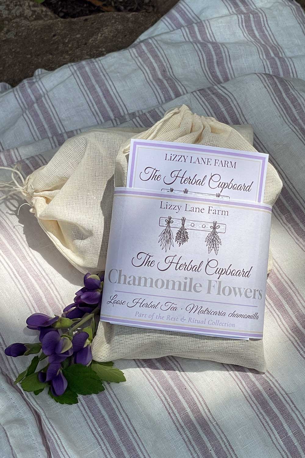 chamomile flower loose tea packaging with close up of label and tea brewing guide.