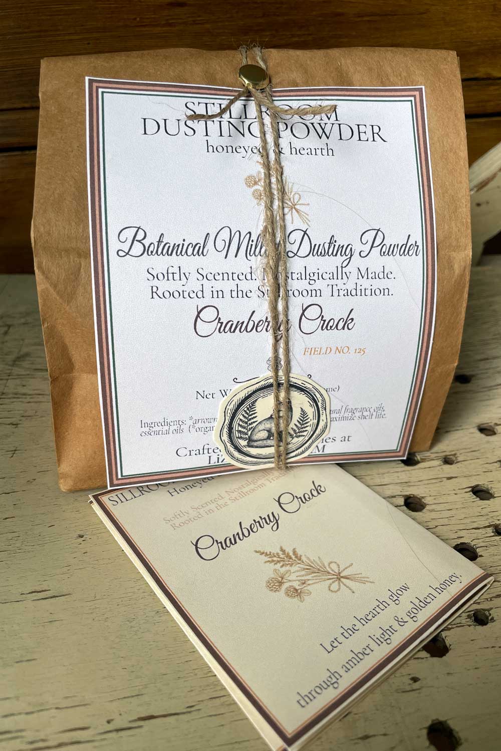 Cranberry Crock Dusting Powder, 12 oz bulk edition with Stillroom Archive fragment cards — vintage farmhouse style with clover and goldenrod icon.