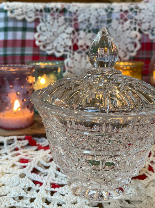 Dazzling Shannon Crystal powder jar glowing with sparkle in sunlight, placed on lace dressing table.