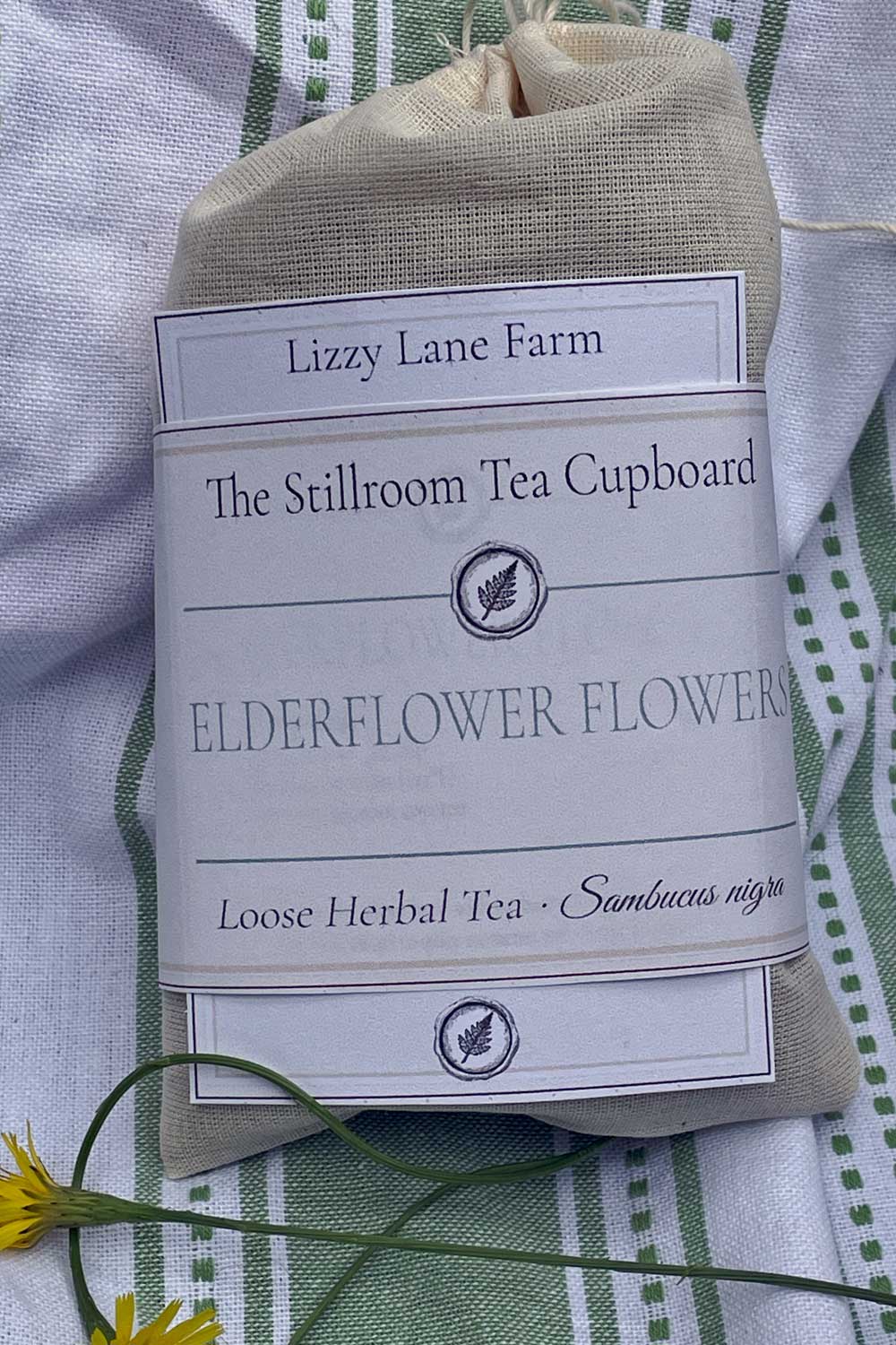 Loose elderflower tea in a muslin bag