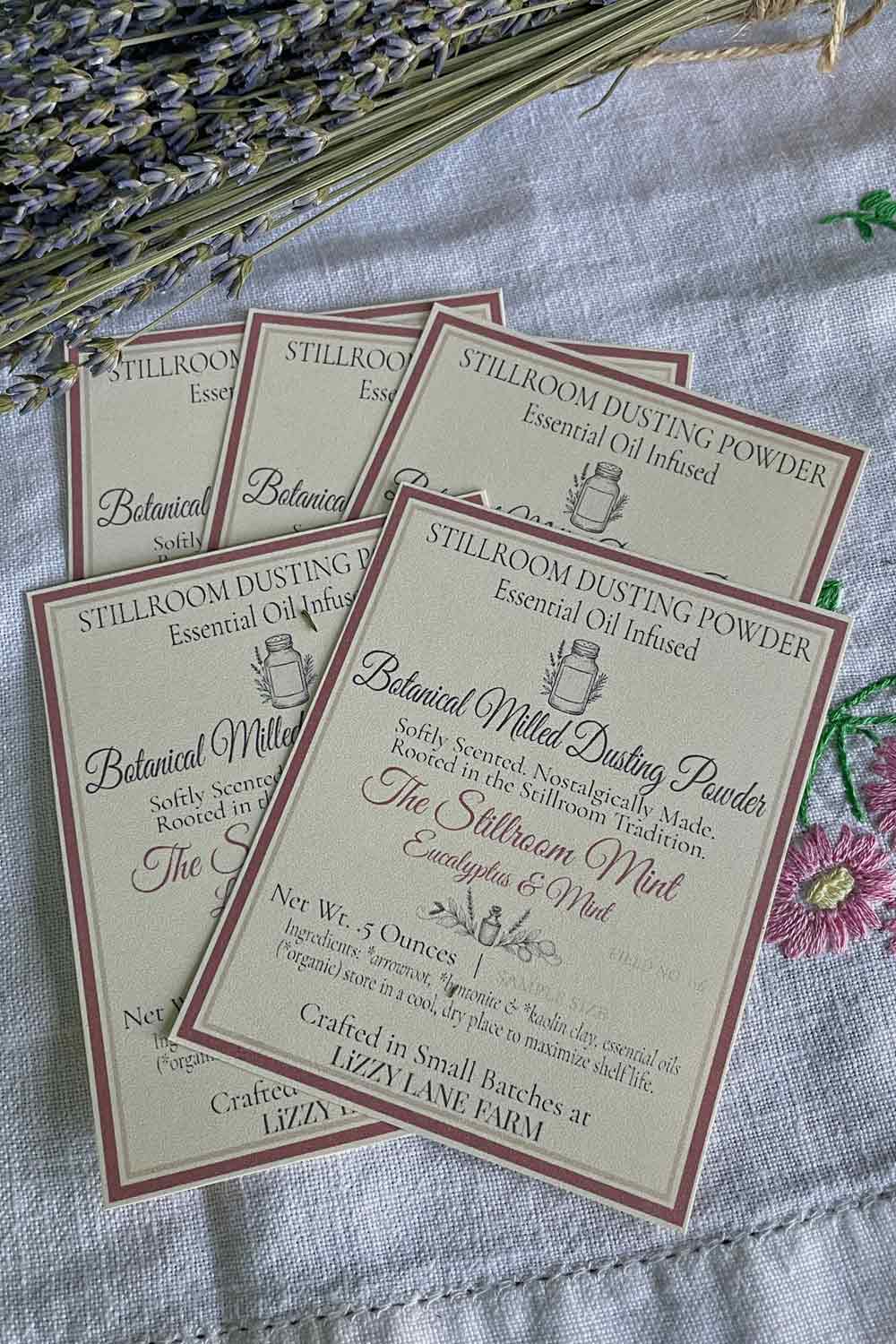 Essential Oil Infused Dusting Powder cards from Lizzy Lane Farm — Stillroom Mint labels surrounded by dried lavender, part of the Stillroom Archive collection.