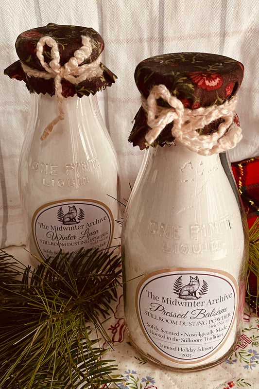 Vintage pint milk bottles filled with limited-edition Midwinter dusting powder, cottagecore gift set with crochet ties and rose calico caps, perfect for cozy farmhouse Christmas gifting.
