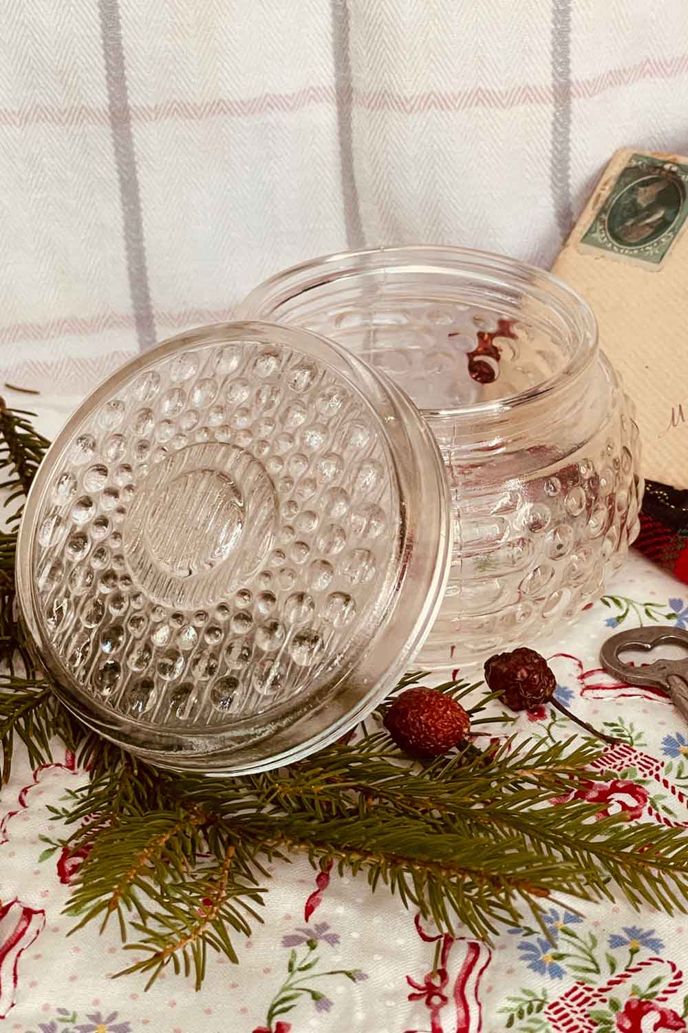 Close-up of vintage hobnail pressed-glass powder dish showing raised texture and soft blush tone — perfect for holiday gifting and morning rituals.