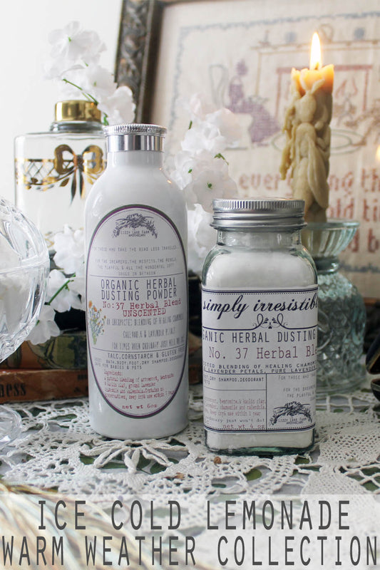A vintage glass apothecary bottle and a brushed aluminum shaker sit atop an antique dresser, accompanied by a softly glowing candle and a lace doily, evoking a sense of timeless charm and summer nostalgia.