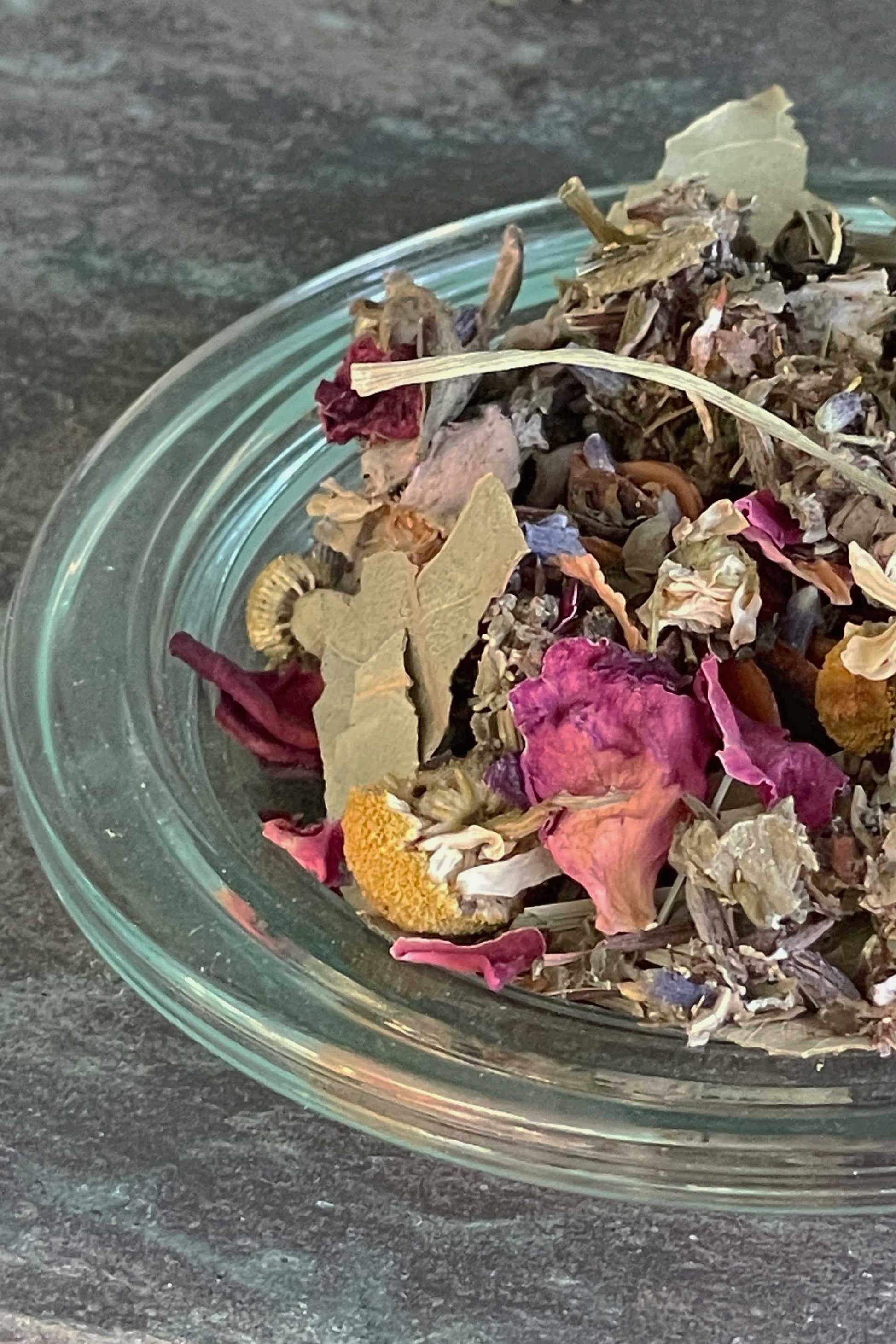 Close-up of Night Garden multi-use botanical blend with dried rose petals, chamomile flowers, sage leaves and lavender