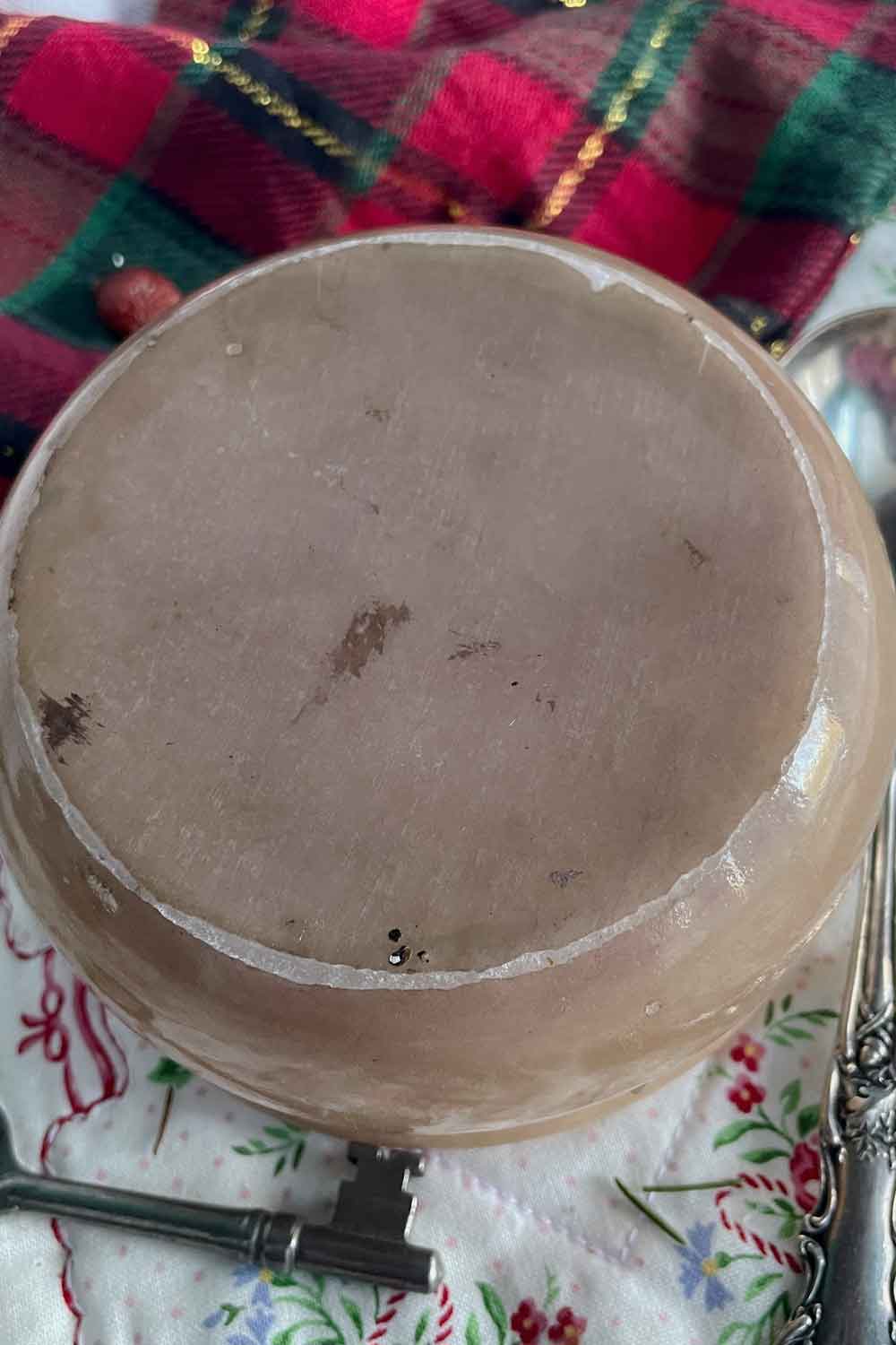 Underside of vintage alabaster powder dish showing natural stone wear — perfect collectible gift for vintage lovers and winter powder rituals.