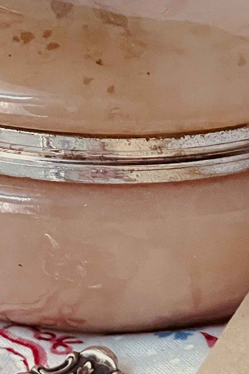 Detail of aged gold-tone metal band on the vintage alabaster powder jar — classic holiday gift for Stillroom powder lovers and vintage vanity collectors.