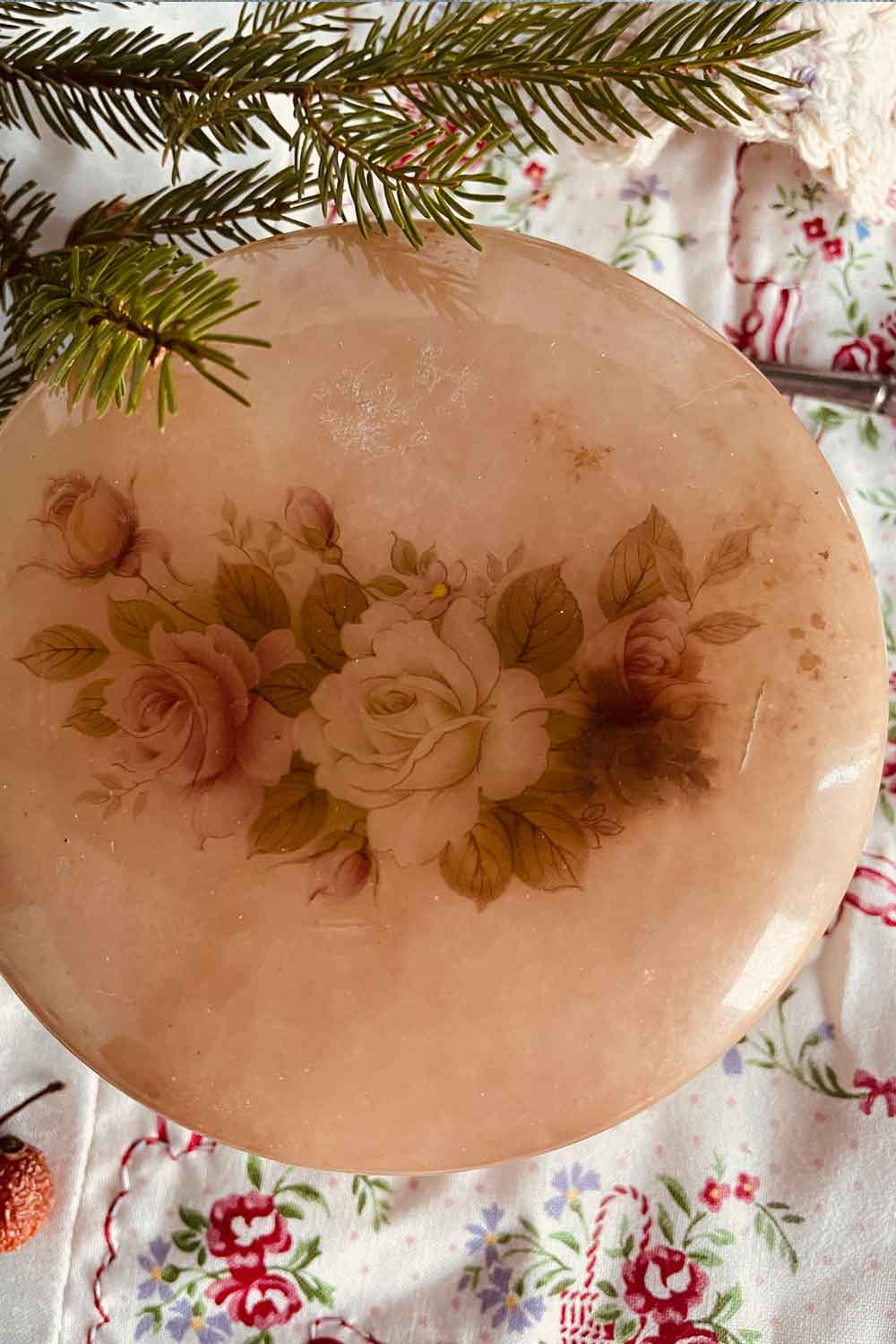 Close-up of floral rose applique on the pink alabaster powder dish — a charming vintage vanity piece for holiday gifting and handmade body powder.