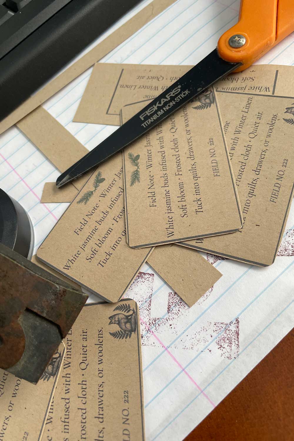 Stillroom workbench with winter dusting powder tags, wooden letter press letters, and handmade stationery — behind-the-scenes of the winter holiday gift guide.