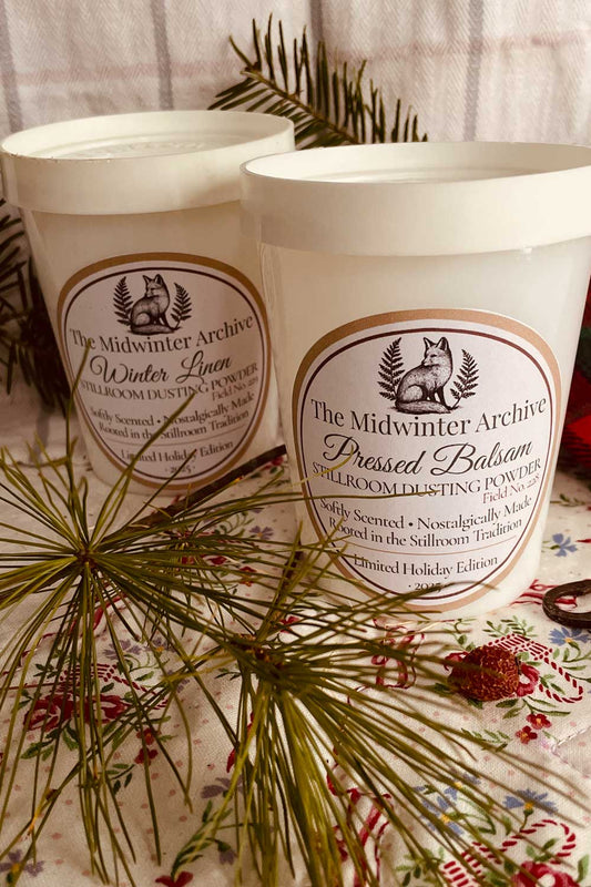 Midwinter Archive Salton Jar dusting powders in vintage 1970s milk-glass jars with pine sprigs — limited edition winter cottagecore gift set.