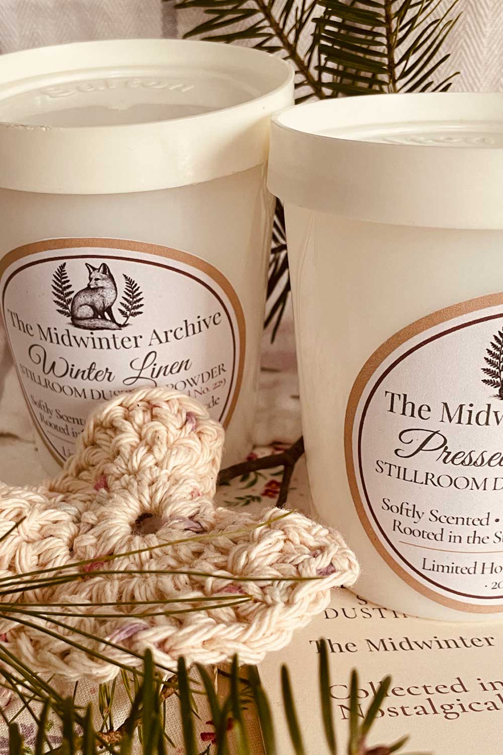 Vintage milk-glass Salton jar with Winter Linen label, handmade crochet puff, and evergreen sprigs — nostalgic winter bath and body gift.