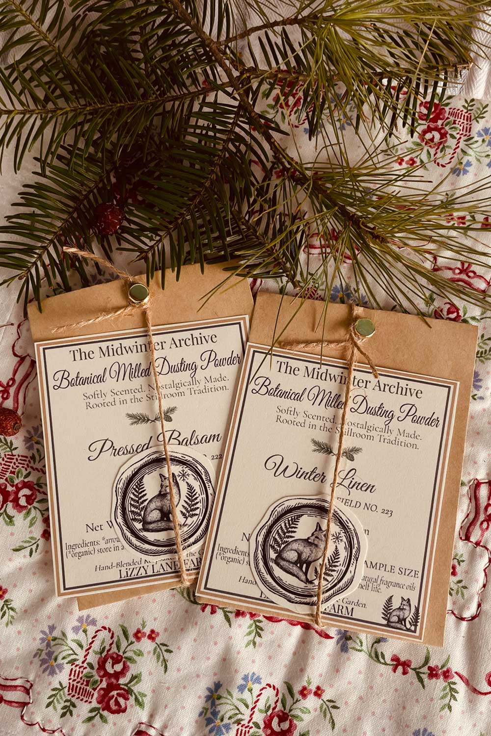 midwinter archive sample powders, pressed balsam and winter linen tucked in on holiday table with winter spruce and pine