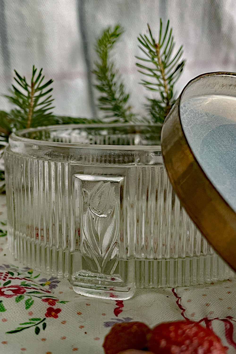 Art Deco vintage powder dish with floral pressed-glass sides and aged brass lid, photographed with winter greens and dried berries for a Christmas stillroom look — ideal as a vintage vanity gift.