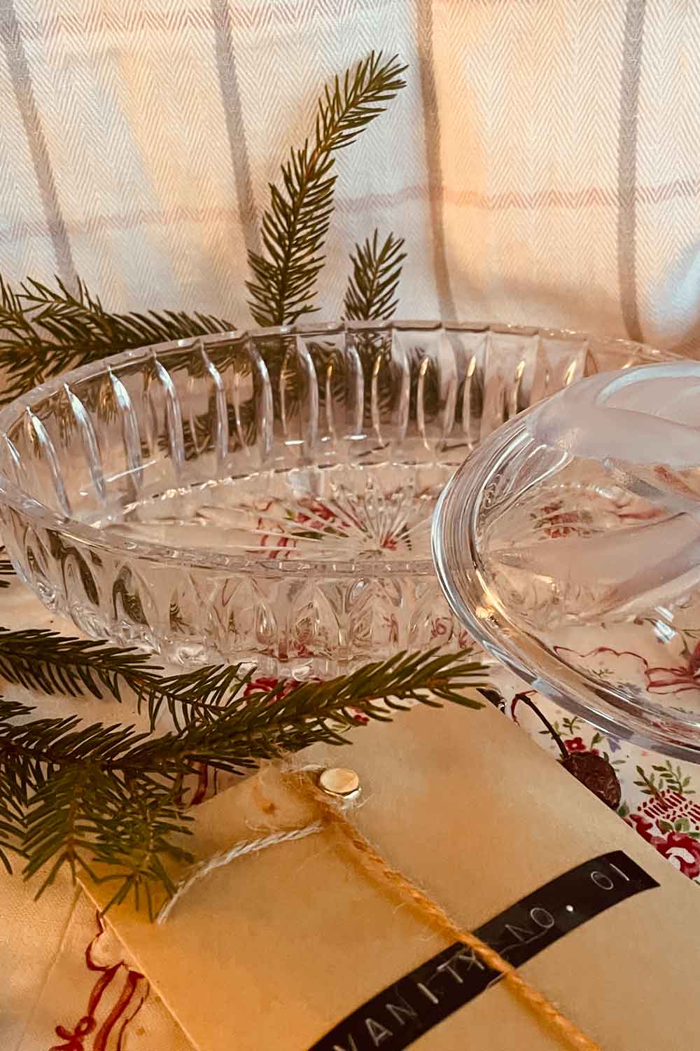 Open vintage pressed-glass powder dish showing interior space for handmade dusting powder, oval shape and clear bell design visible.