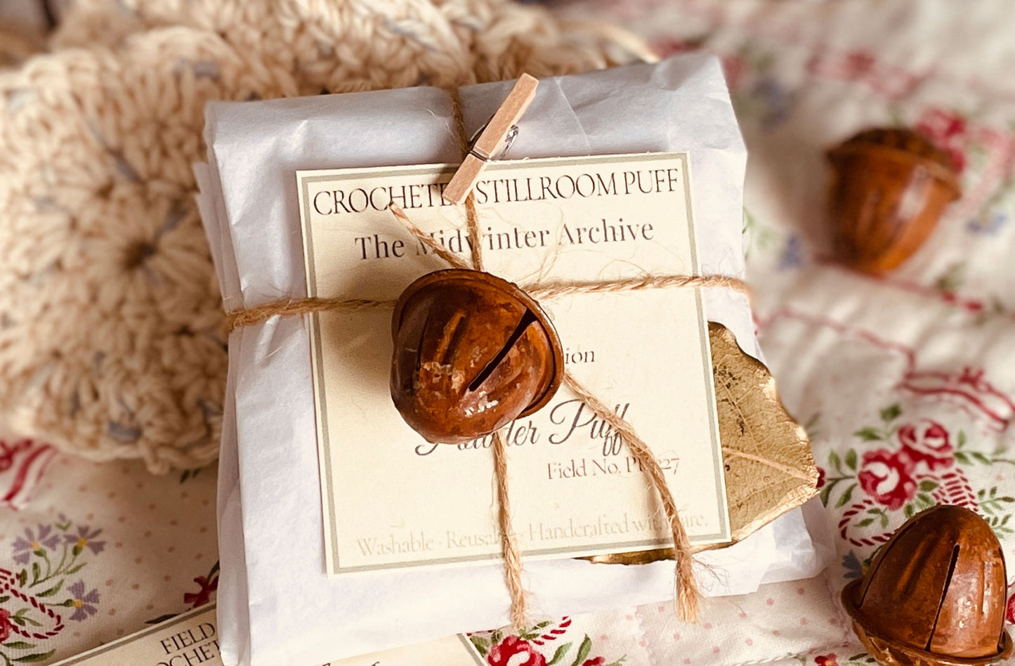 Handcrafted Midwinter Archive dusting powder puffs wrapped in cloth and twine with copper bells — limited edition holiday stillroom collection by Lizzy Lane Farm.