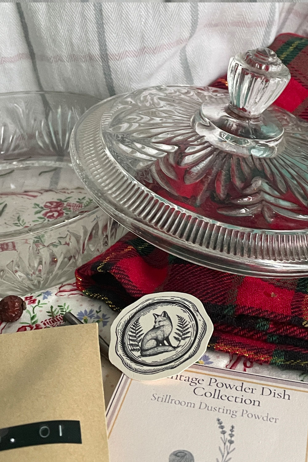 Vintage 1960s Avon Crystalique powder jar with lid removed, showing the pressed-glass pattern and winter stillroom styling.