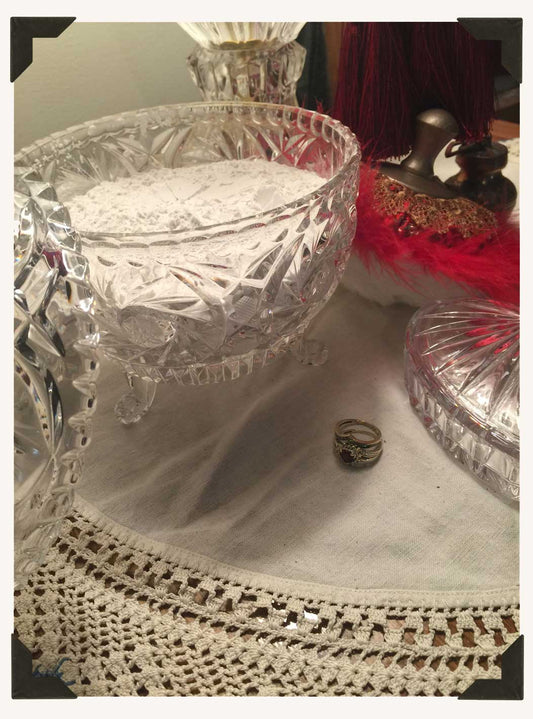 Freshly milled dusting powder available in bulk, resting in a vintage powder dish