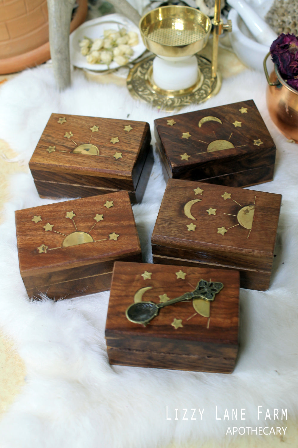 Display of several closed wooden boxes featuring intricate brass inlay designs. Each box showcases unique brass detailing, highlighting the craftsmanship and elegance of the collection