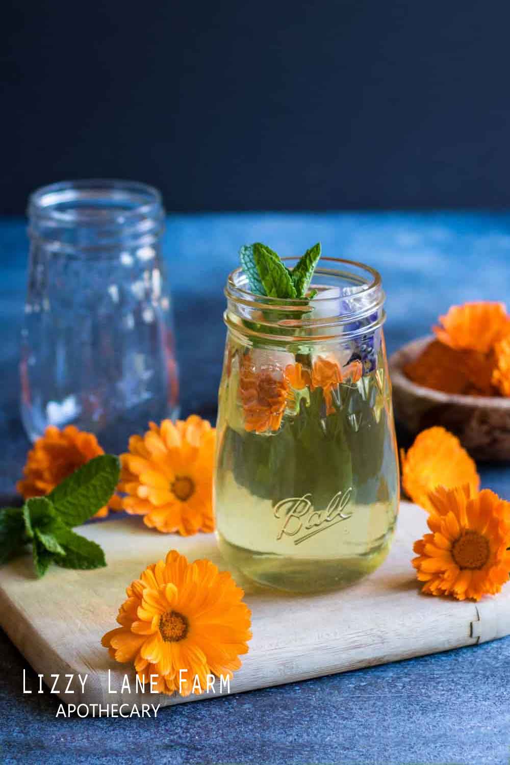 Organic Calendula flower heads infusing in oil to create a soothing, healing salve, with bright orange and yellow petals soaking in the oil, capturing the essence of Calendula’s skin-nourishing benefits.