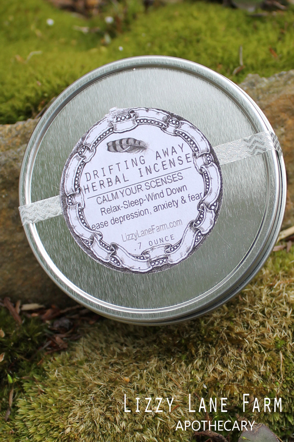 A close-up of the silver tin containing Drifting Away Herbal Incense, showcasing the sleek, reusable packaging. The tin holds a generous amount of calming herbs, including chamomile and lavender, perfect for enhancing relaxation and creating a serene atmosphere in your home.

