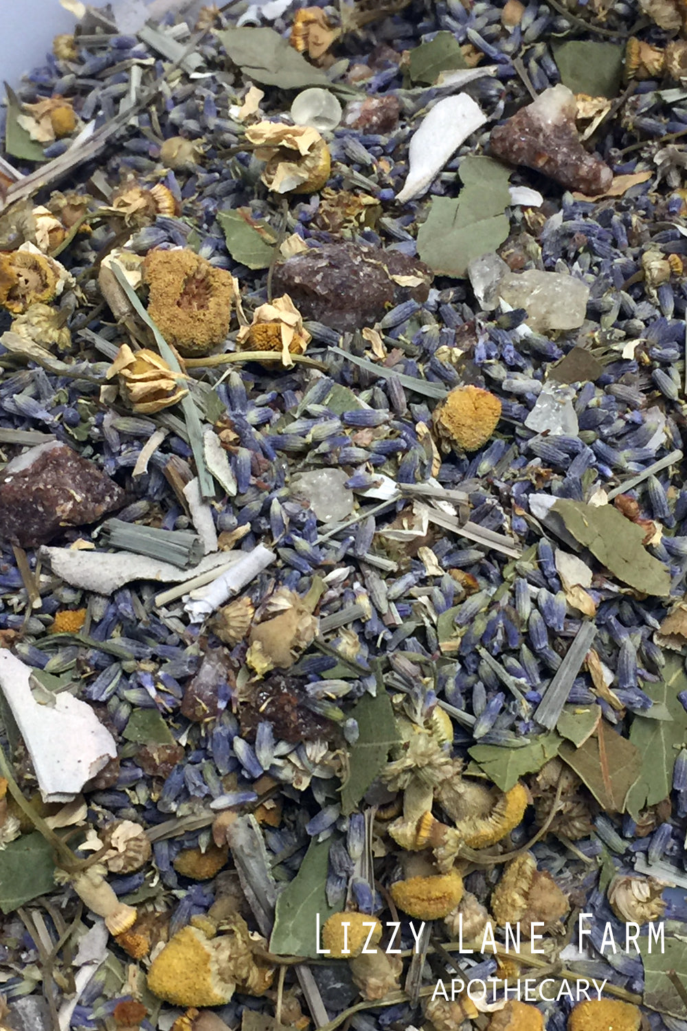 A close-up of loose herbs ready to be made into Drifting Away Herbal Incense. The image shows a blend of chamomile, lavender buds, and other calming herbs, waiting to be burned for a soothing, relaxing experience. Perfect for creating a peaceful atmosphere in your home.