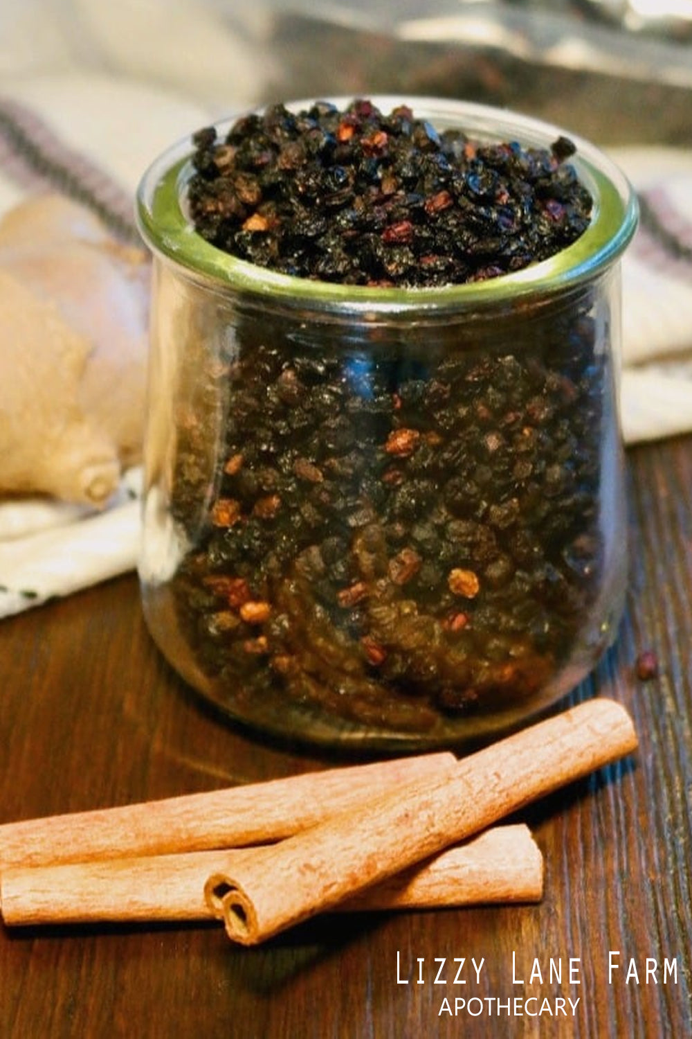 organic dried bulk elderberries in a mason jar with cinnamon sticks ready to make syrup.