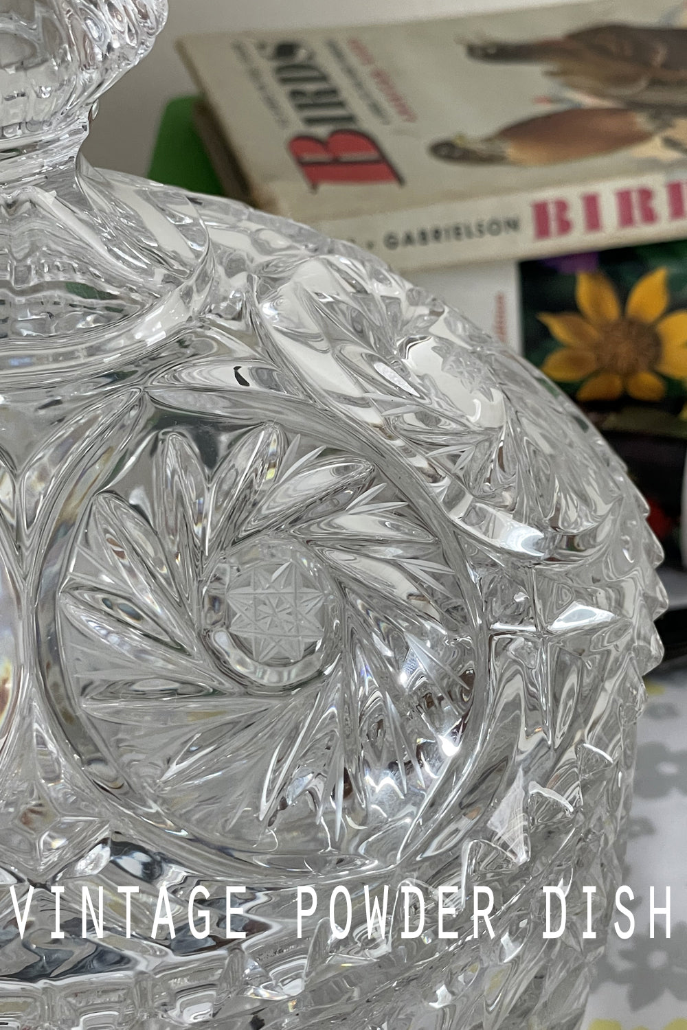 Close-up of lead crystal powder dish lid with detailed cut design, sparkling in the light.
