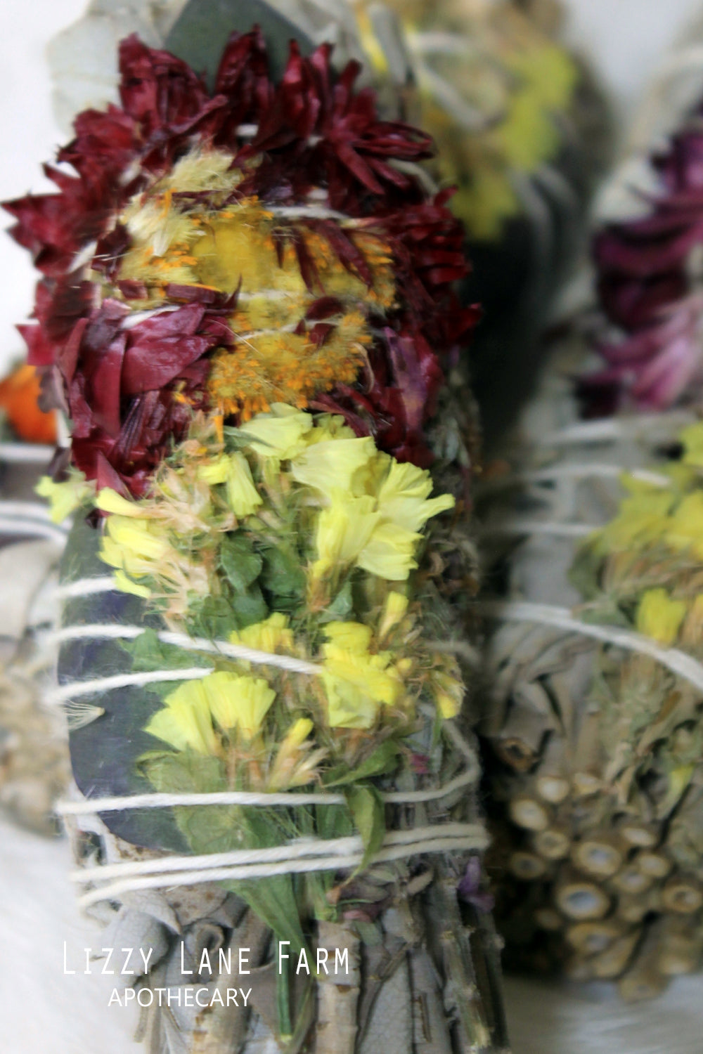 close up of dried flowers woven into the mountain sage and copal infused herbal bundle.