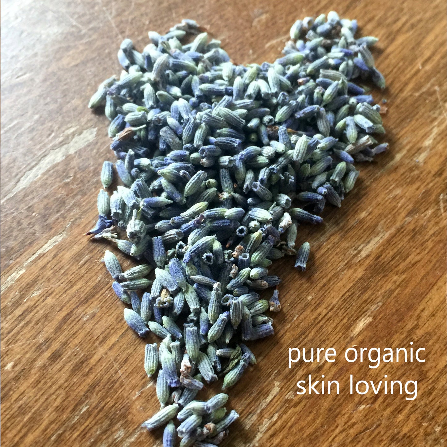 a beautiful pile of organic lavender shaped into a heart. the lavender buds used to make the single essence lavender perfume oil