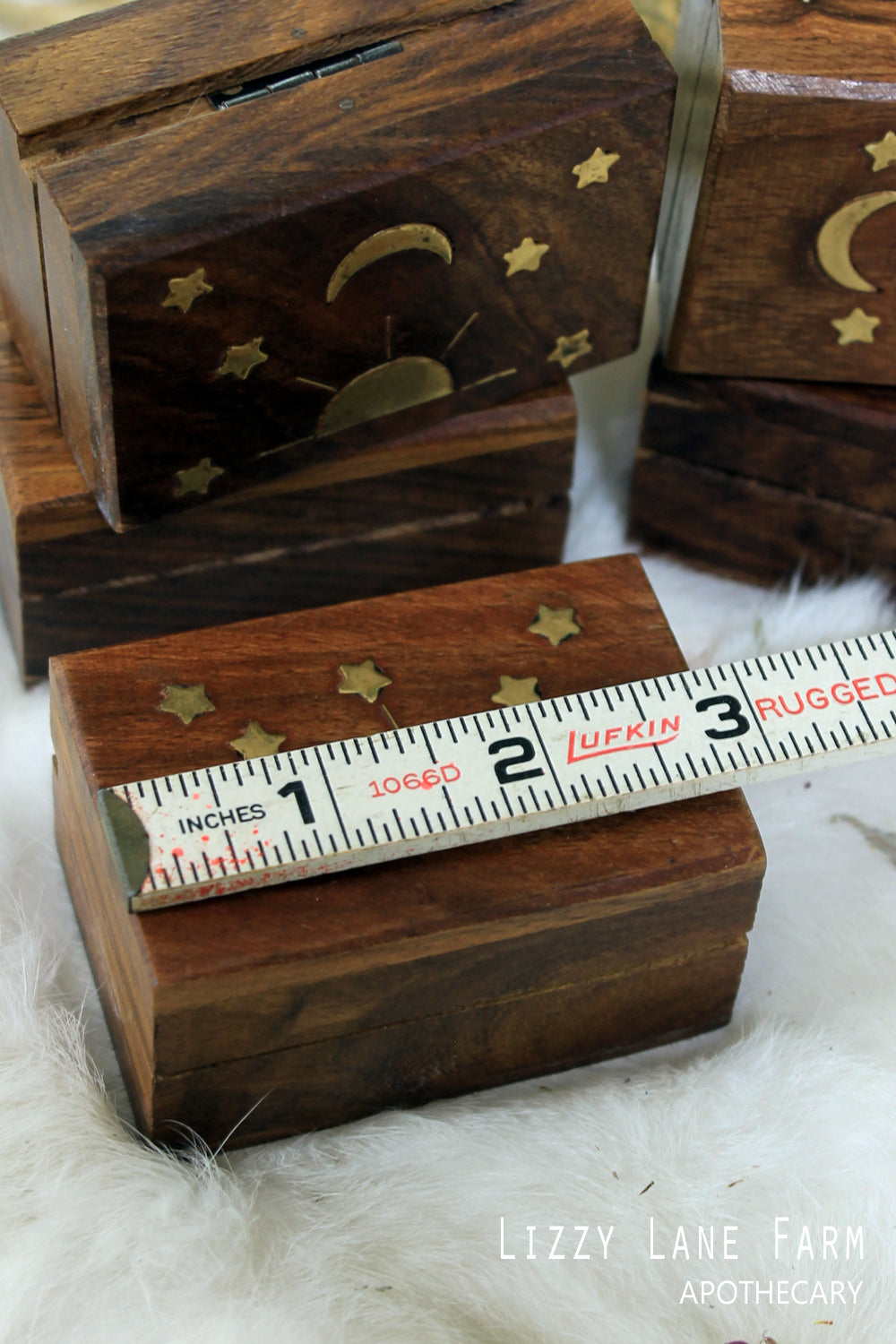 Close-up of a brass inlay wooden box with detailed celestial patterns, showcasing the intricate craftsmanship. A ruler is included to highlight the box's size, providing a sense of scale. This beautifully handcrafted box is perfect for storing Myrrh resin, making it an elegant and functional addition to your everyday ritual for peace and relaxation