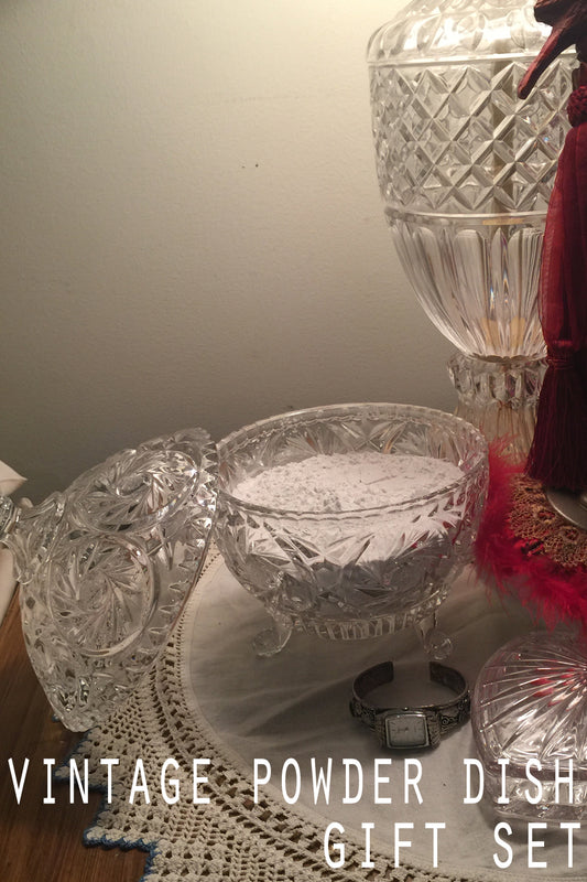 vintage powder dish sitting on the vanity full of body powder and red dusting puff